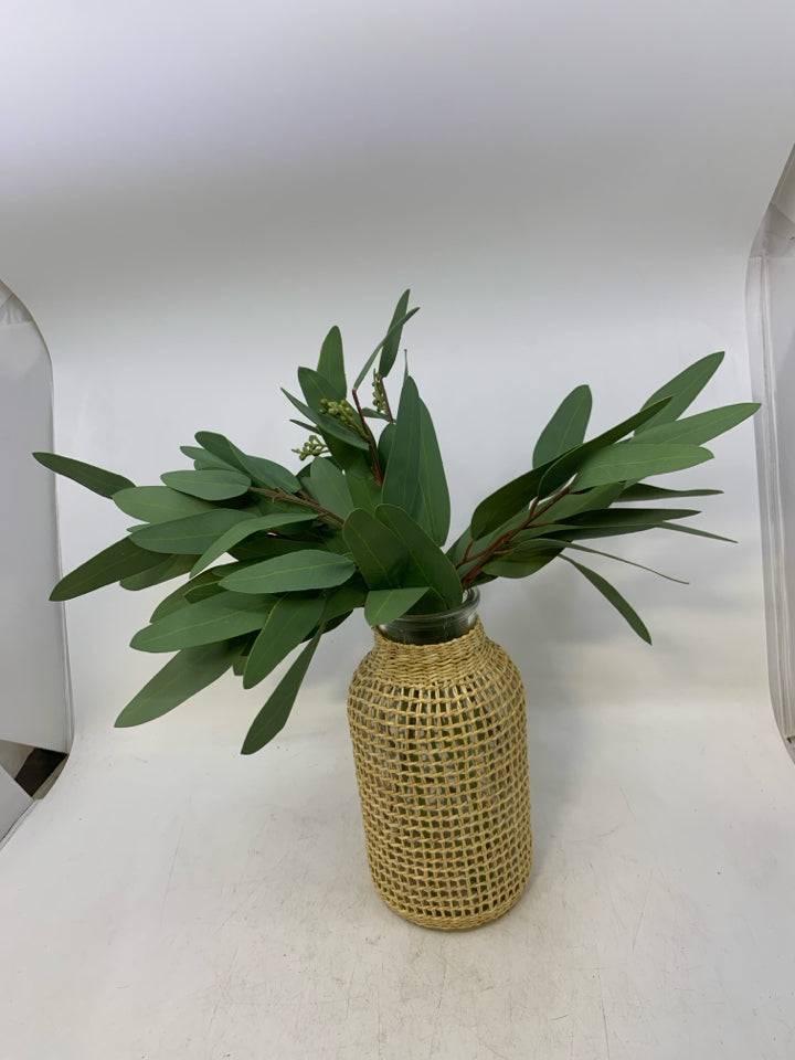 GLASS VASE W/ WOVEN WEAVE OVER IT FAUX LEAVES FILLER.