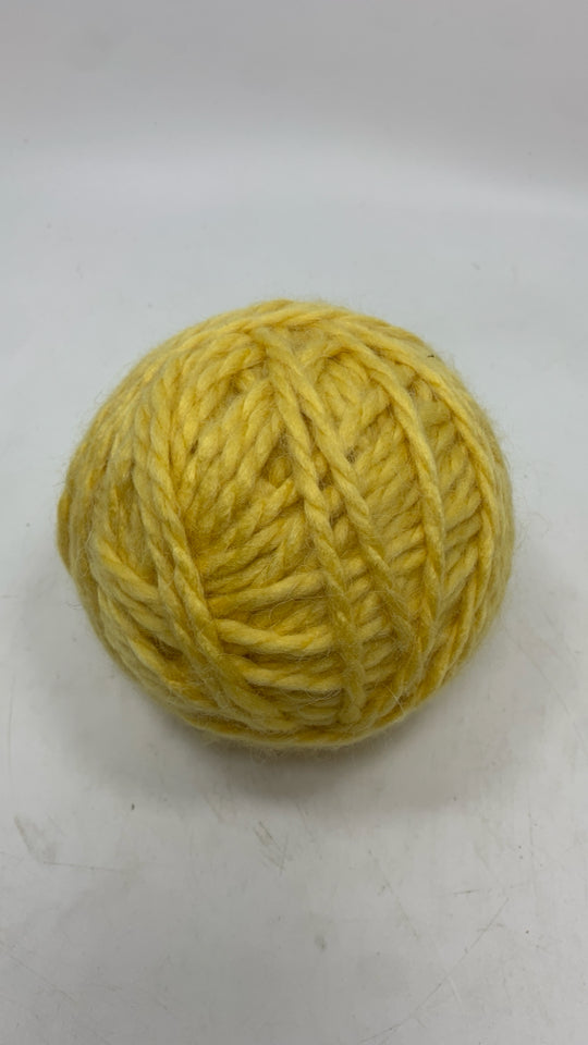 ROUND YELLOW SOFT YARN BALL.