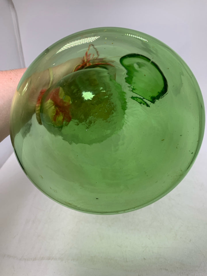 GREEN GLASS 2 COMPARTMENT DECANTER W/ WOVEN STOPPER.