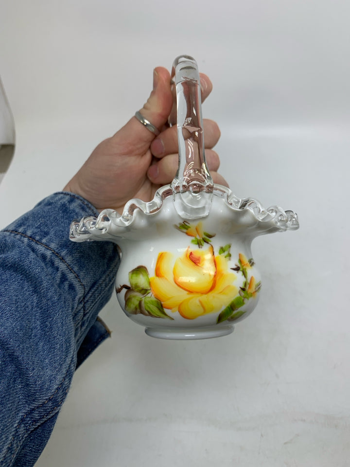 MILK GLASS BASKET W/ PAINTED YELLOW FLOWERS CLEAR HANDLE.