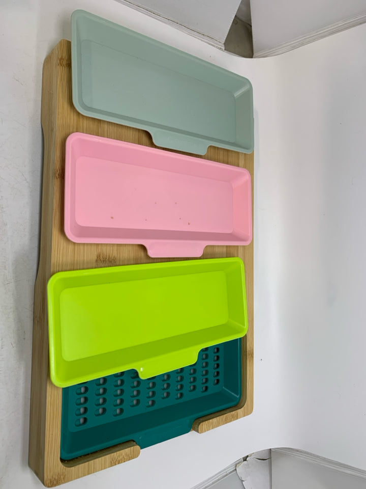 WOOD CUTTING BOARD W/ PLASTIC INSERTS.