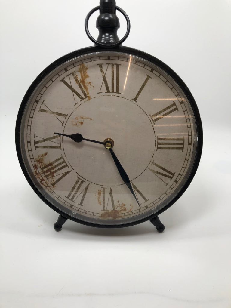 SM DISTRESSED STANDING METAL CLOCK.