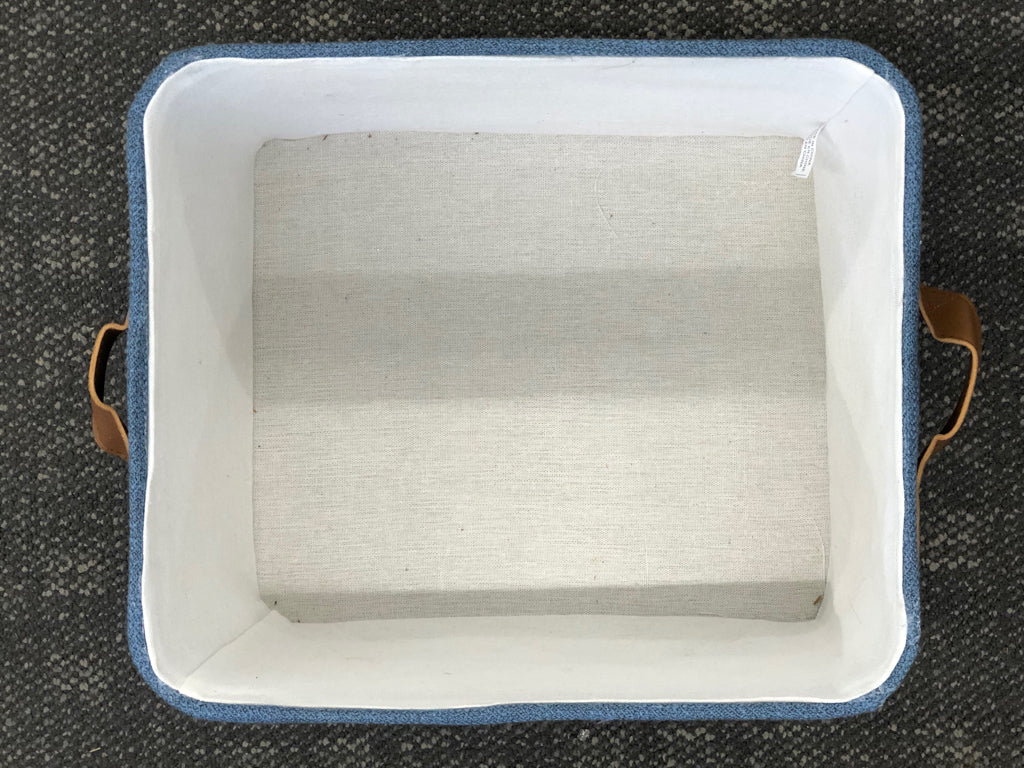 BLUE FABRIC STORAGE BIN W/LEATHER HANDLES.