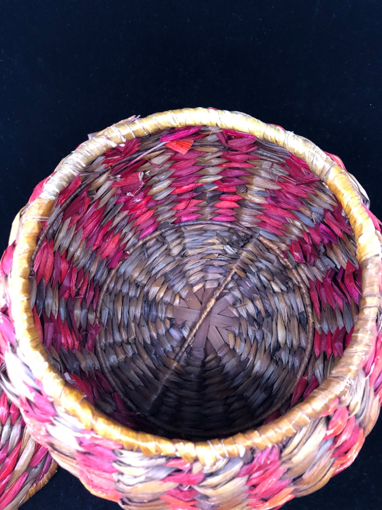 MULTI COLORED WOVEN COVERED BASKET.