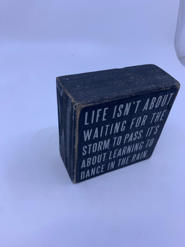 LIFE ISNT ABOUT WAITING FOR THE STORM TO PASS WOOD BLOCK.
