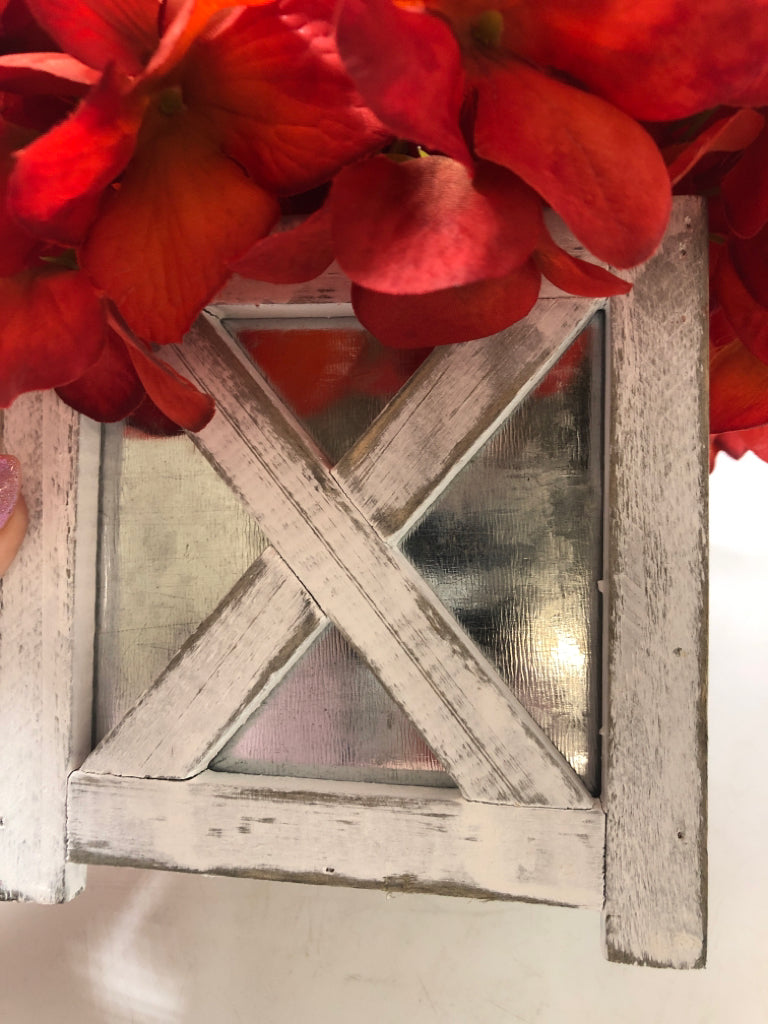 RED FLORALS IN "X" FRAME PLANTER.
