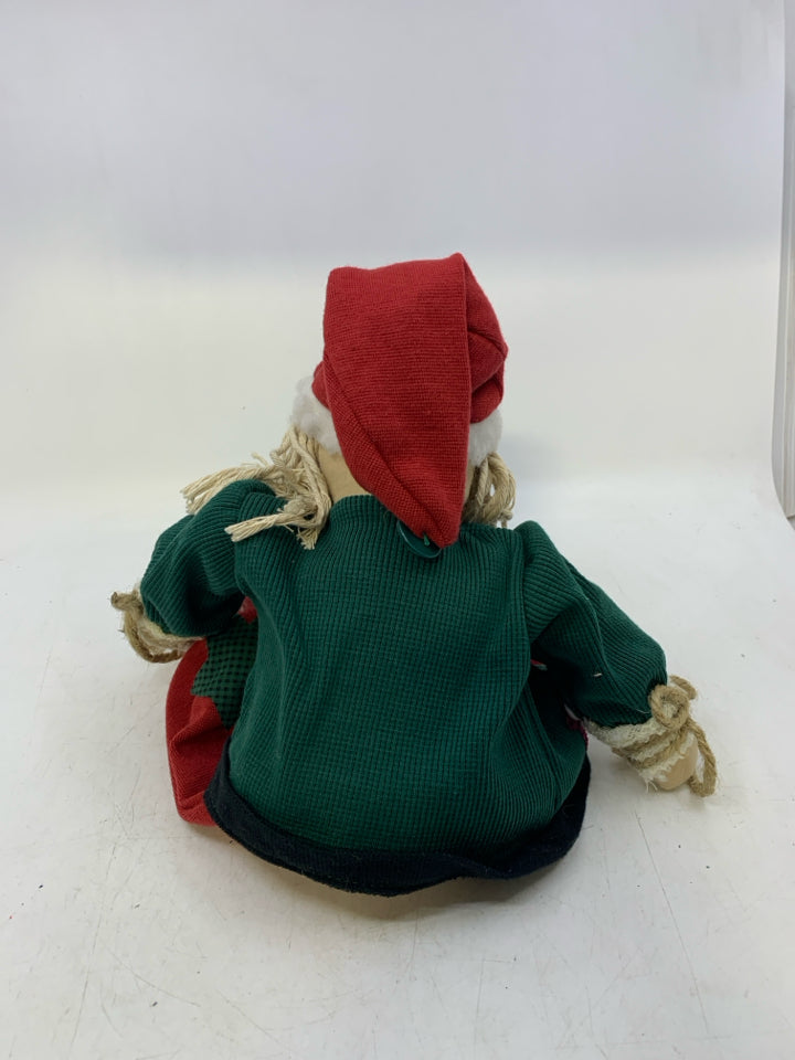 PLUSH PRIMITIVE STYLE SHELF SITTING SANTA GREEN COAT/RED PANTS.