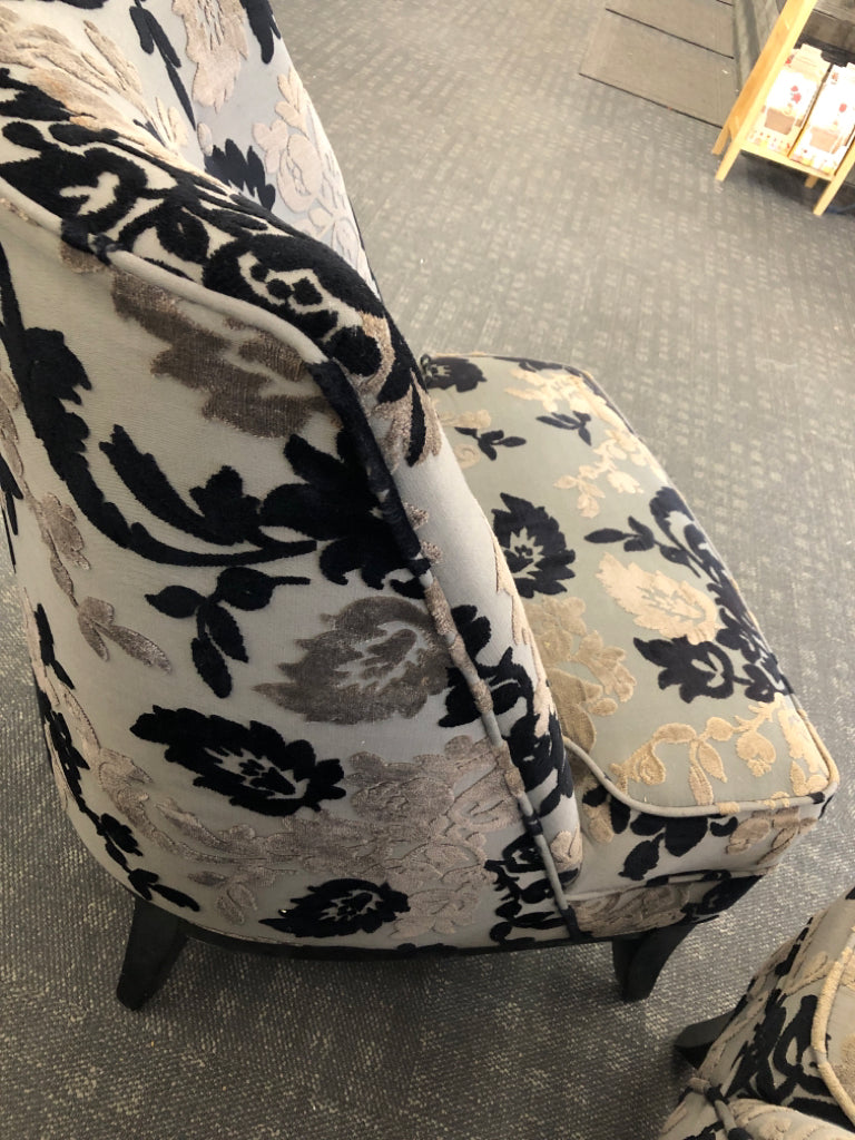 BLACK FLORAL UPHOLSTERED CHAIR W/ WOOD LEGS.