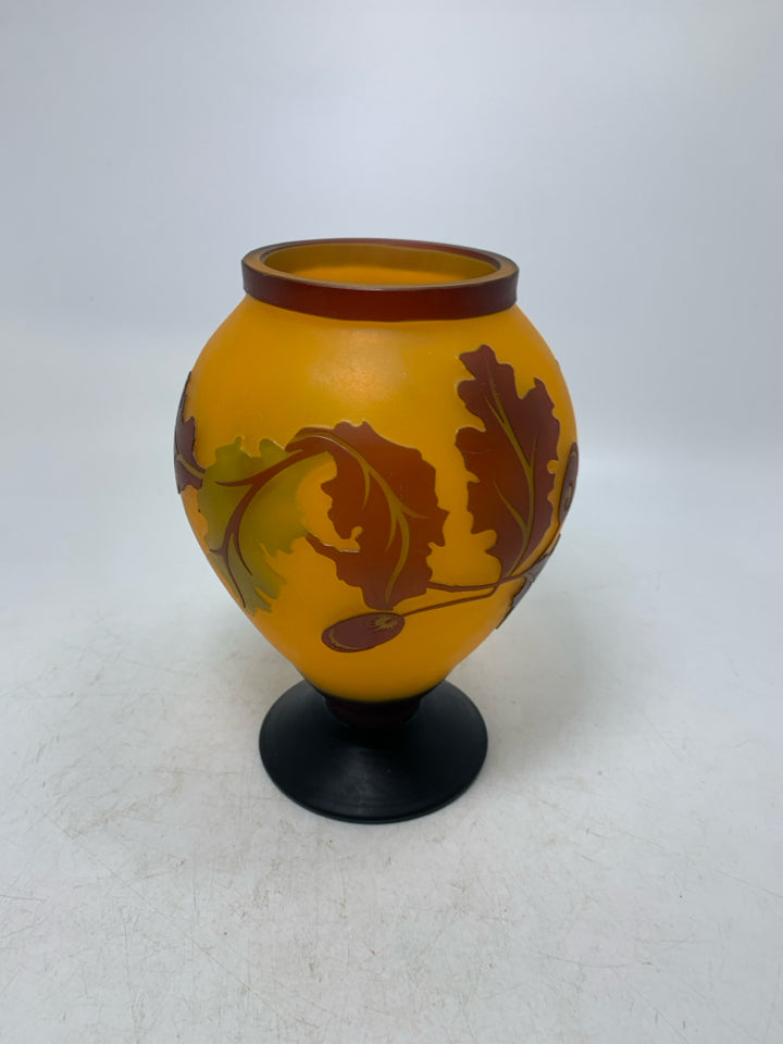 EMBOSSED ORANGE LEAVES/ACORN FOOTED VASE.