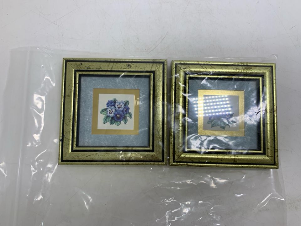 2 MINI VIOLET/PANSY FLOWER PICTURES IN GOLD FRAMES IN BAG.