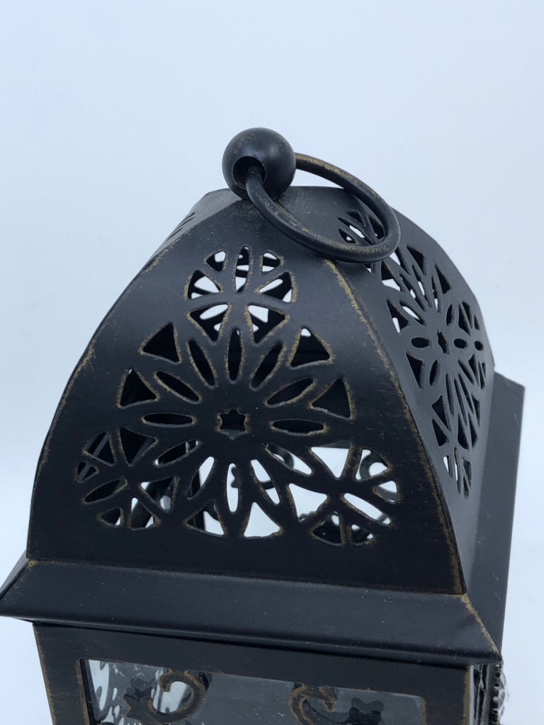 SMALL LANTERN W/ GLASS PANES JEWELS IN MIDDLE PIERCED TOP.