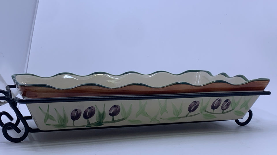 OLIVE CASSEROLE DISH IN METAL HOLDER.