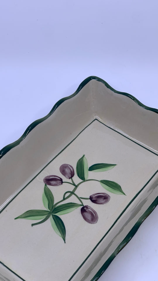 OLIVE CASSEROLE DISH IN METAL HOLDER.