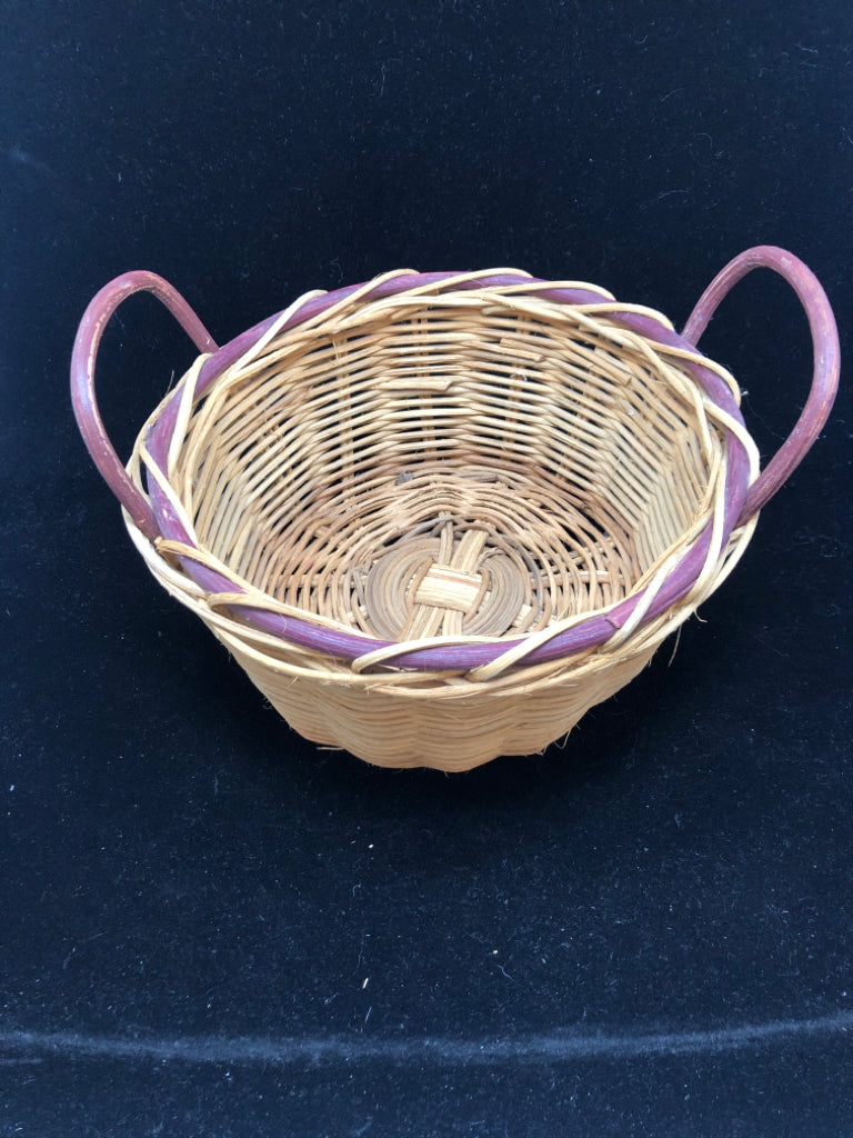ROUND WOVEN BASKET W/PURPLE RIM AND HANDLES.