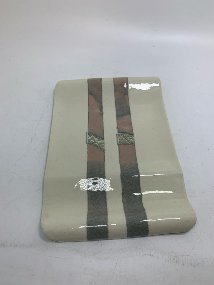 CREAM UNEVEN POTTERY TRAY W/ PINK GRAY STRIPES.