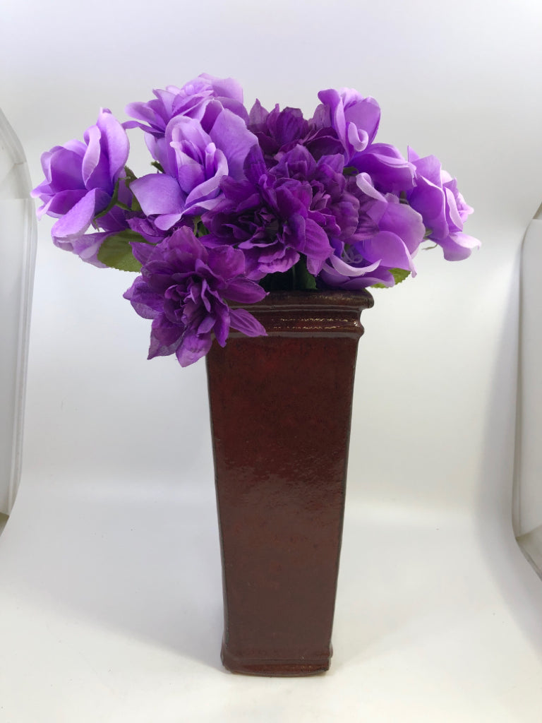 RED CERAMIC SQUARE VASE W/FAUX PURPLE FLOWERS.