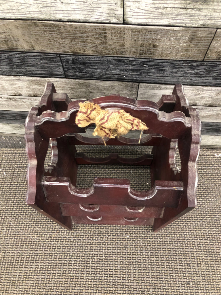 PRIMITIVE WINE HOLDER.