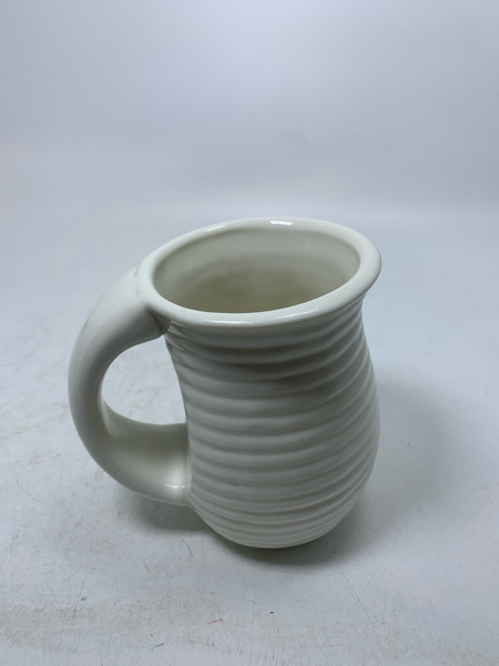 WHITE RIBBED MUG W/ CARDINAL SITTING ON WREATH.
