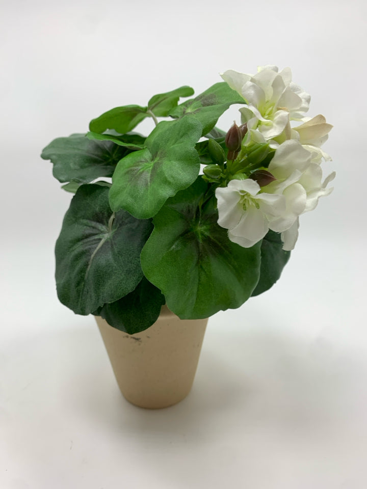 FAUX GERANIUM IN TAN POT.