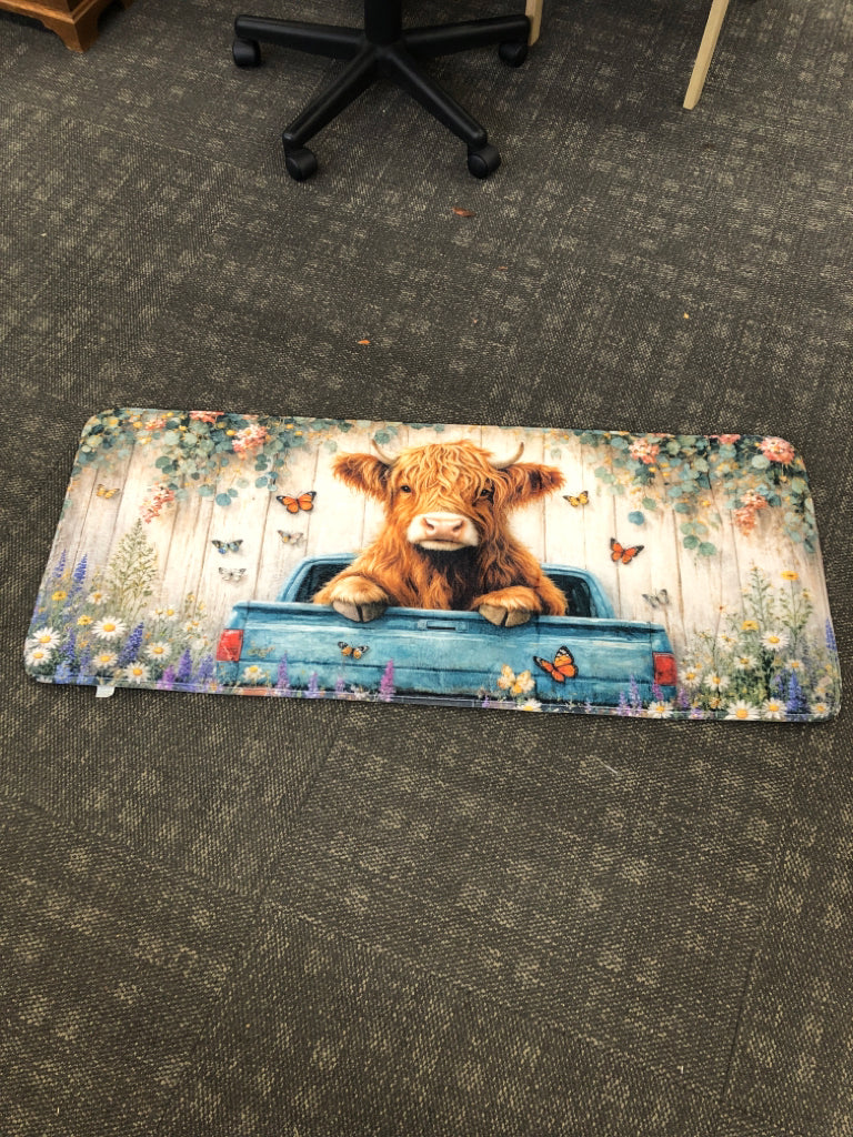 PLUSH HIGHLAND COW ACCENT RUG.