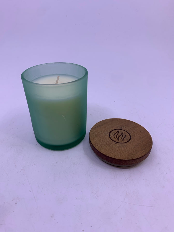 NEW BALANCE & HARMONY SCENTED CANDLE IN GREEN JAR.