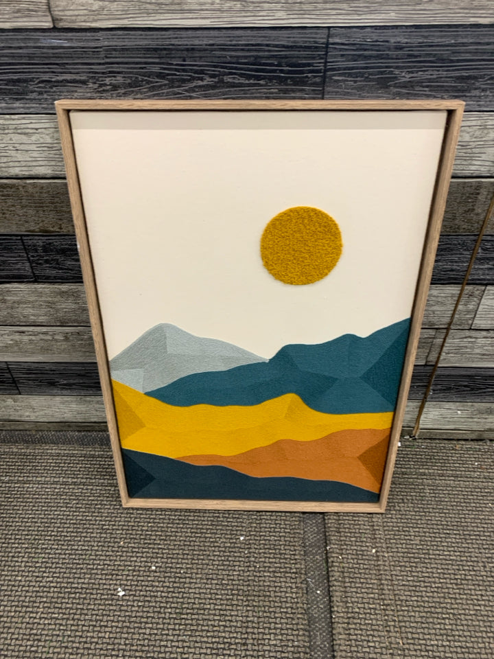 STITCHED SUN WALL HANGING IN TAN FRAME.