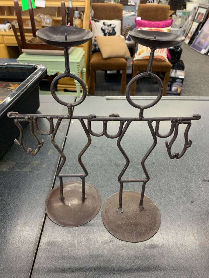 2 BROWN IRON MEN HOLDING FISH CANDLE STICK HOLDERS.