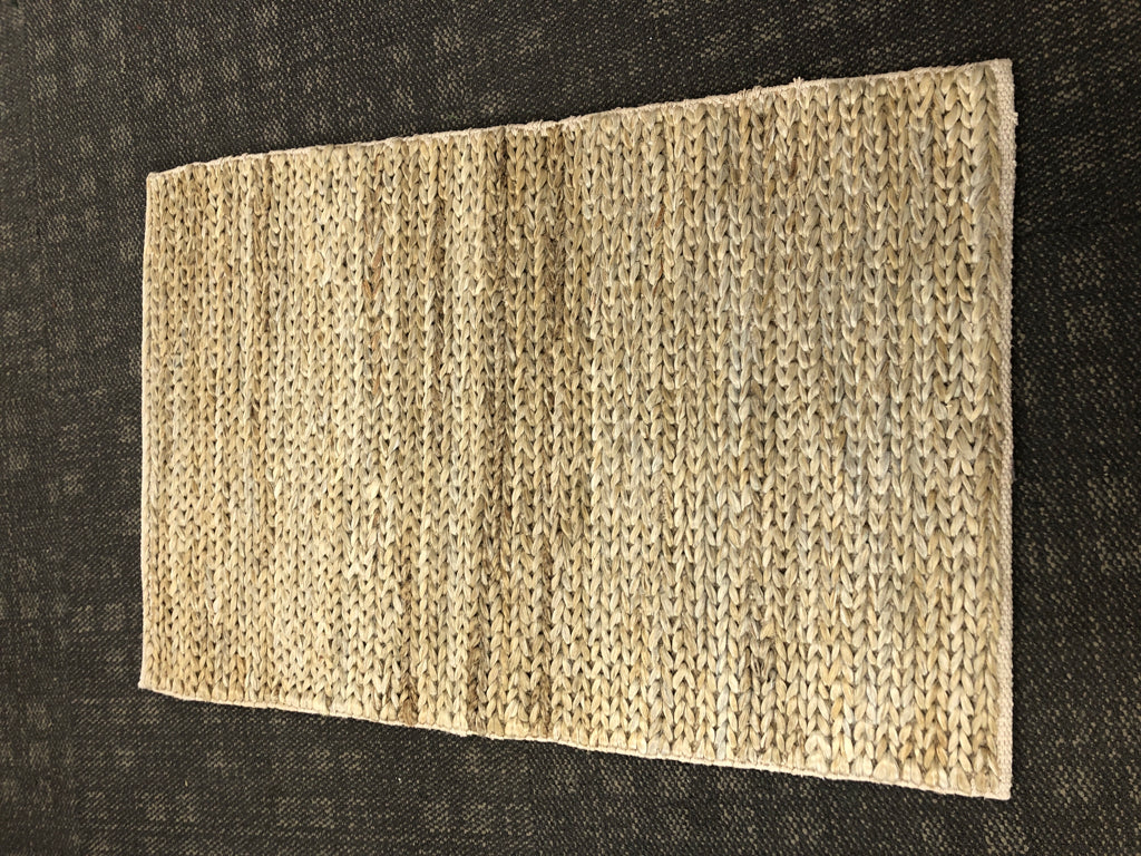 BRAIDED GREY RUG.