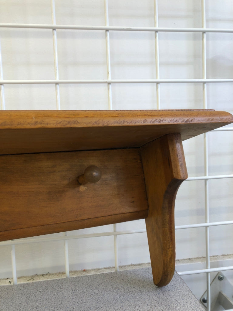 LIGHT BROWN WALL SHELF W/ COAT HOOKS.