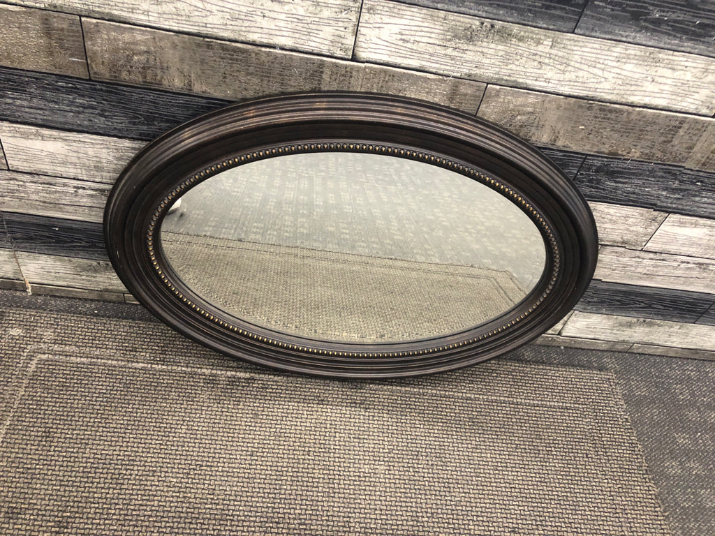 BROWN OVAL HANGING MIRROR.