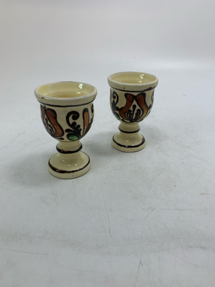 VTG 2 SMALL FOOTED YELLOW EGG CUPS W/ BROWN DETAIL.