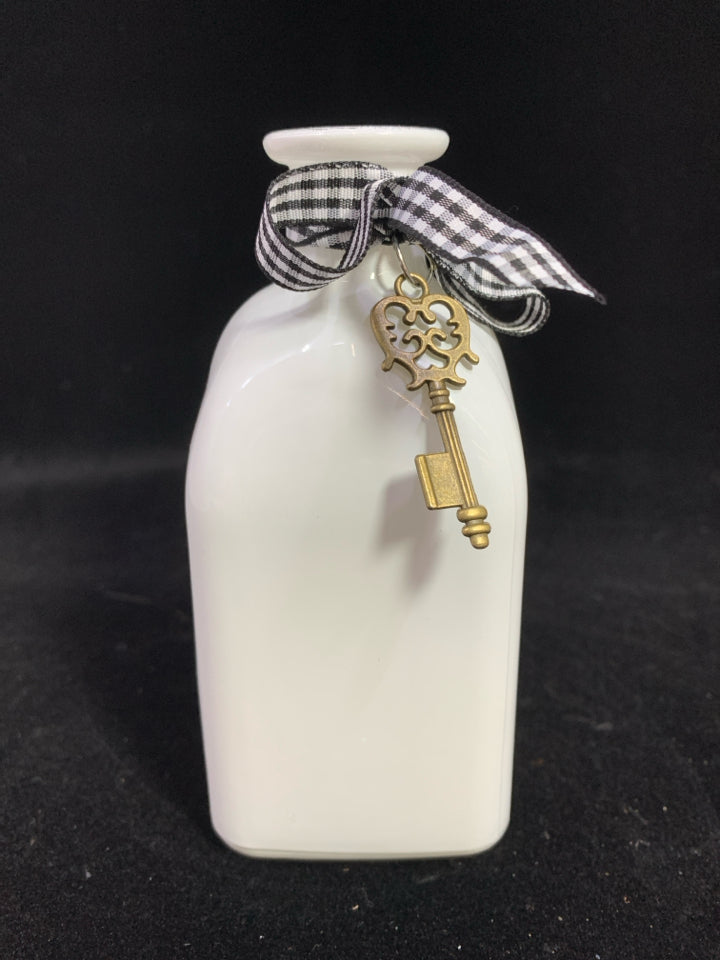 WHITE GLASS BOTTLE W/RIBBON AND KEY.