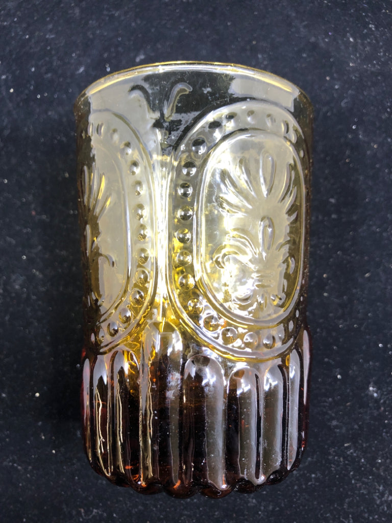AMBER GLASS EMBOSSED TEALIGHT HOLDER.