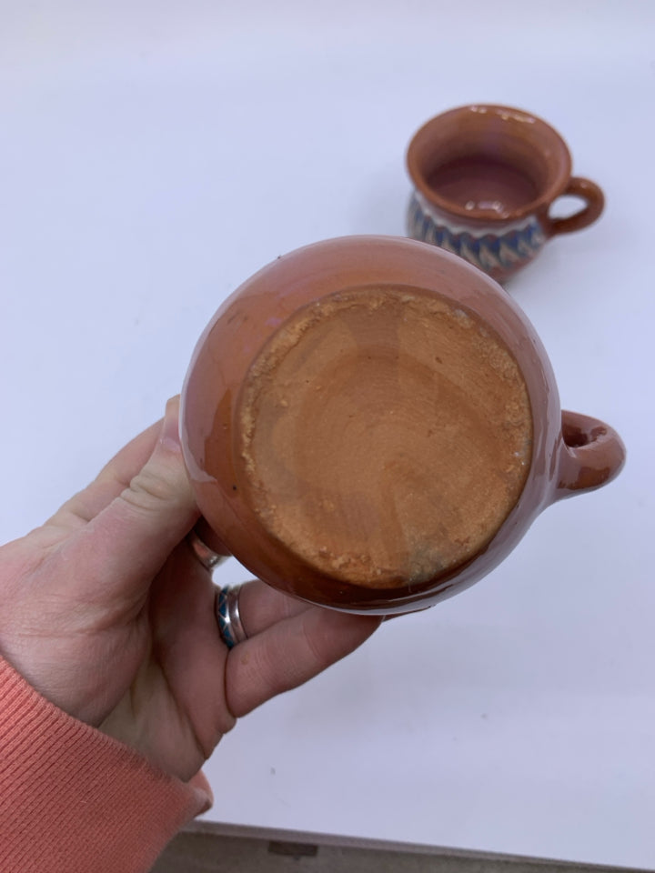 2 TERRA COTTA SHORT MUGS W/ BLUE/WHITE LINES.