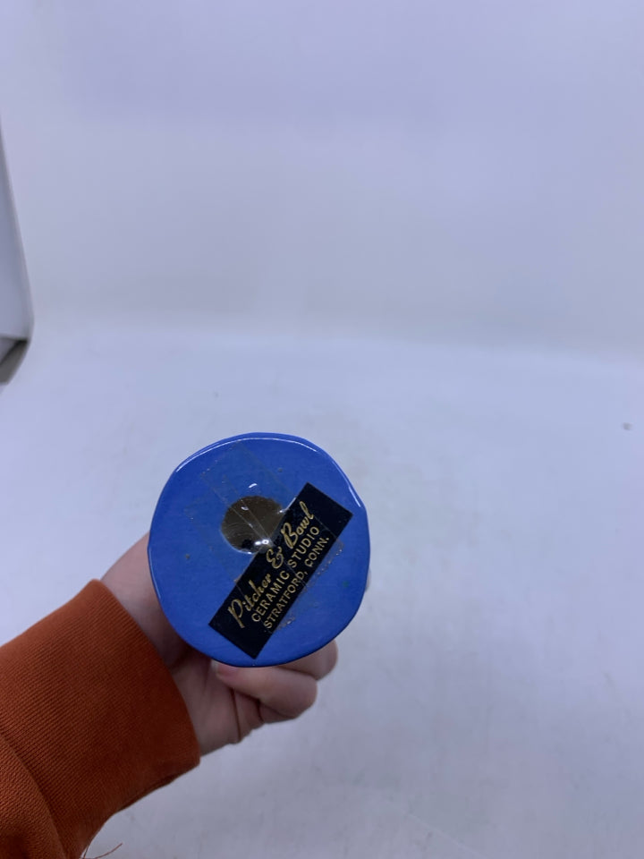 BLUE/GREY BOY W/ HAND ON HIL HOLDING VASE FIGURINE.