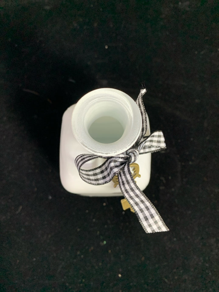 WHITE GLASS BOTTLE W/RIBBON AND KEY.