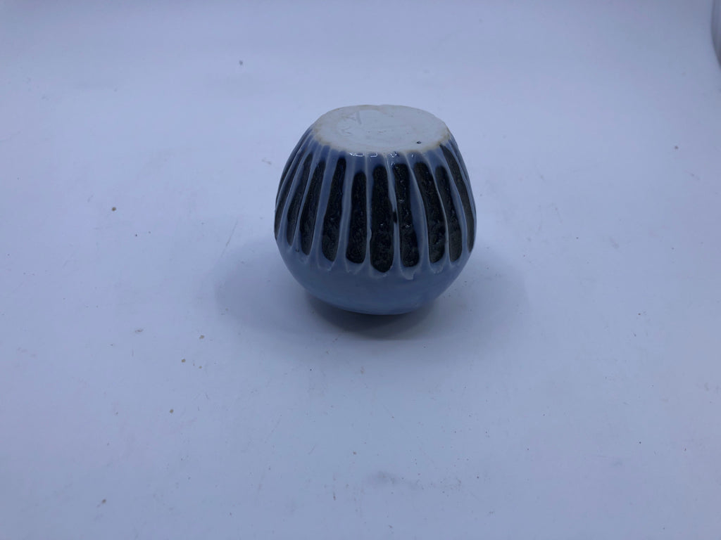 SHORT LIGHT BLUE VASE W/ BLACK LINES ON BOTTOM.