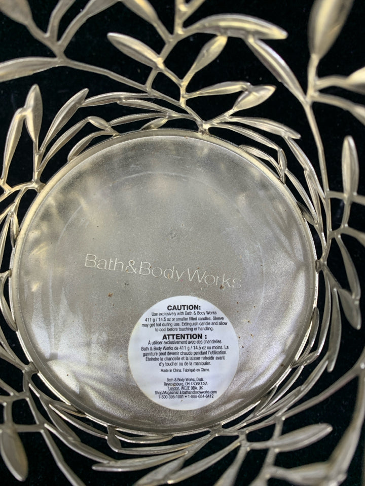FOOTED SILVER METAL CANDLE SLEEVE LEAF DETAIL.