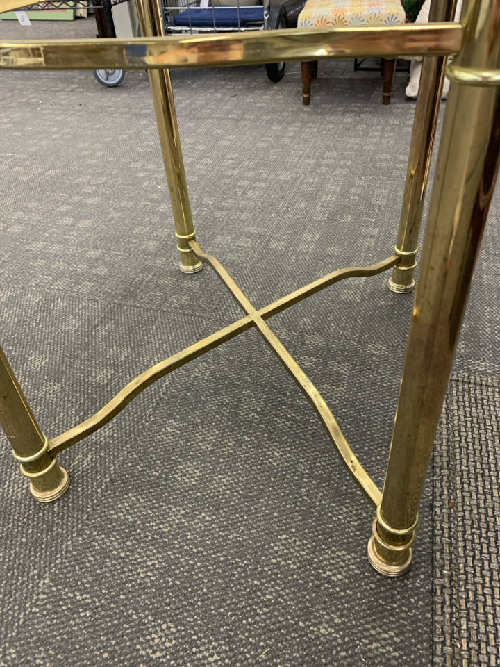 GOLD TABLE W/GLASS TOP AND X BASE.