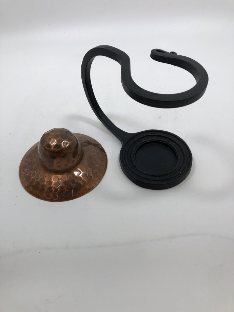 COPPER TEA LIGHT HOLDER IN BLACK METAL STAND.