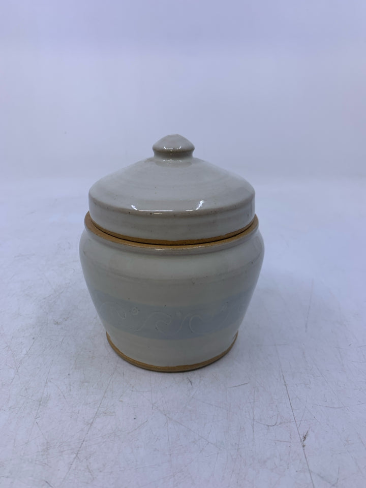 CREAM SHORT POTTERY CANISTER W/ LIGHT BLUE BAND WHITE WAVE OUTLINES.