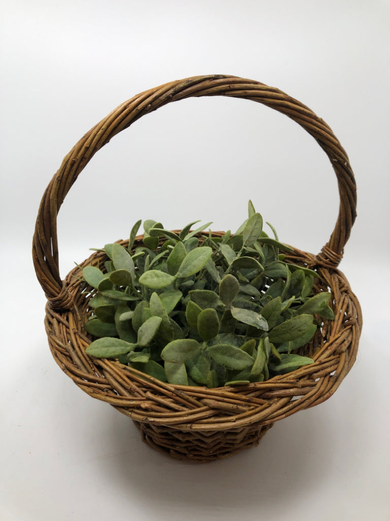 FAUX GREENERY IN WICKER BASKET.