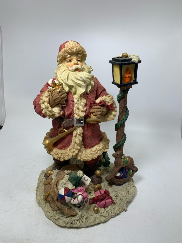 HEAVY RESIN SANTA W/ LAMP POST/ TOYS.