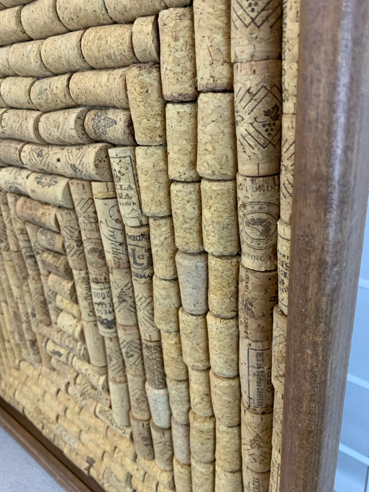 CORKS IN A BROWN FRAME.
