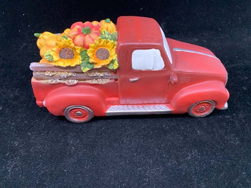 RED TRUCK WITH SUNFLOWERS AND PUMPKINS.