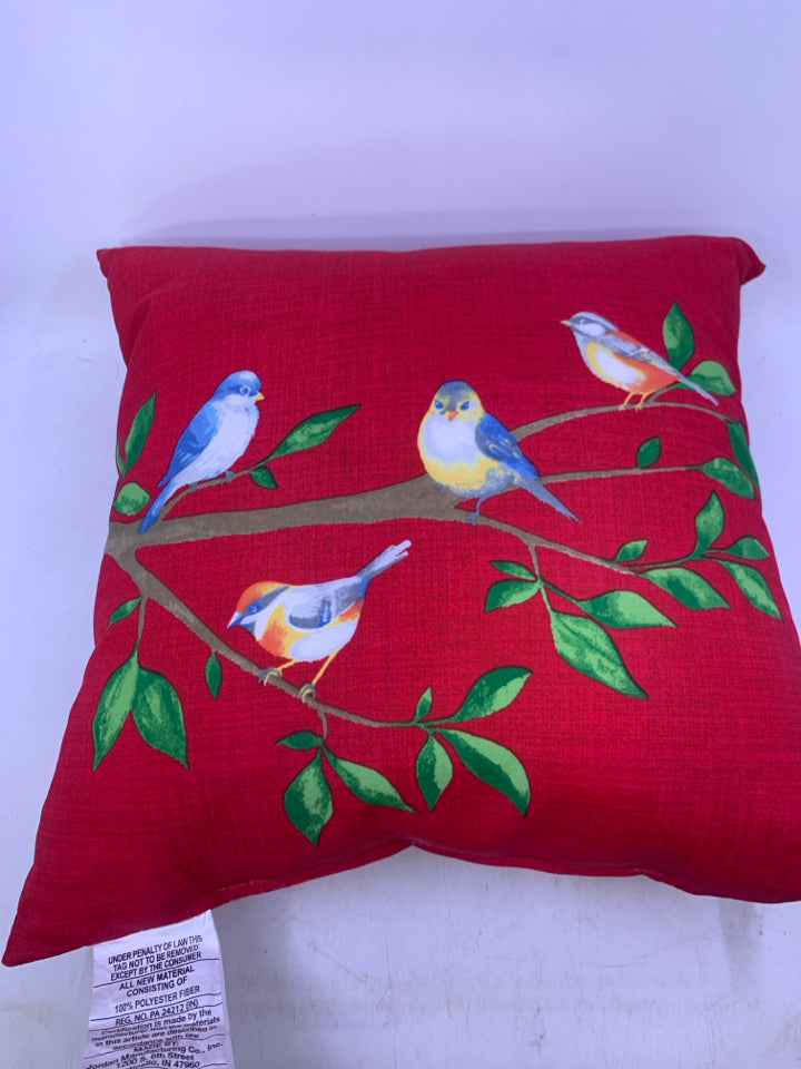 RED PILLOW W/ BLUE BIRDS ON BRANCH.