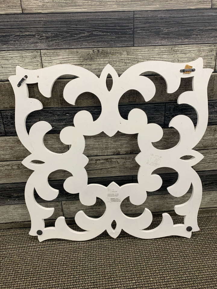 DISTRESSED WHITE WOODEN SCROLLWORK WALL PANEL.