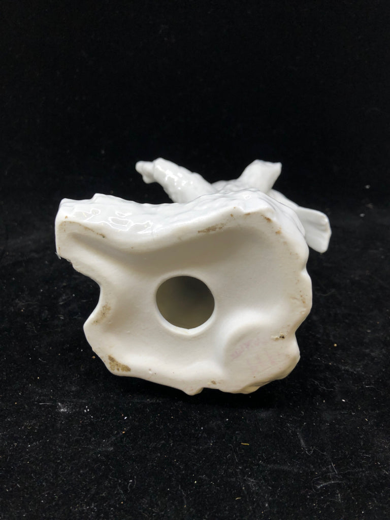 WHITE CERAMIC BIRD ON BRANCH.