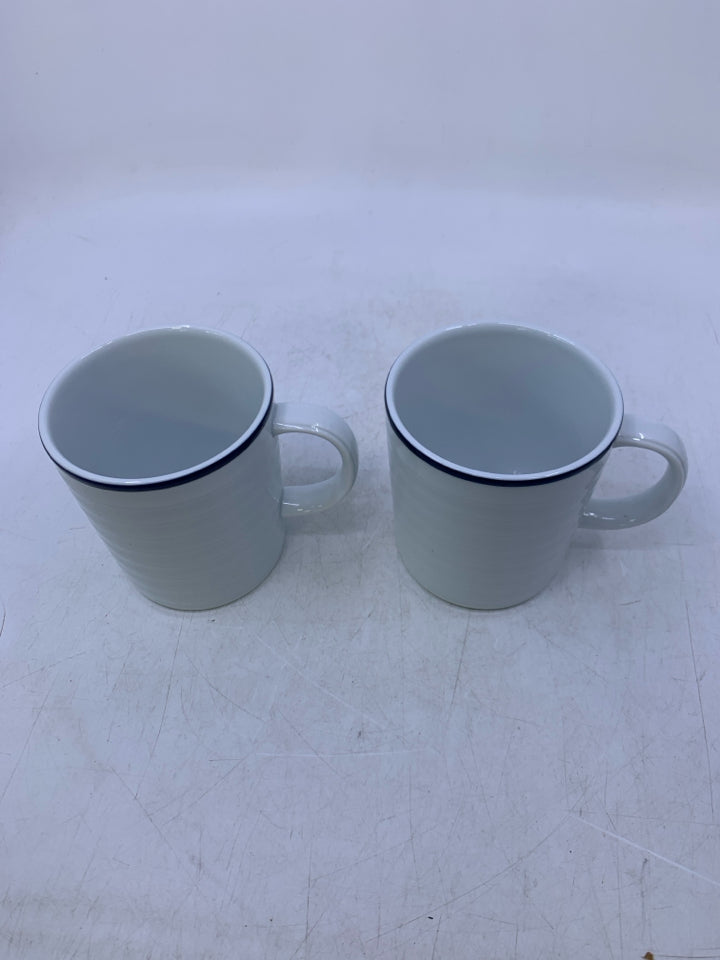 2 WHITE RIBBED MUGS W/ BLUE RIM.