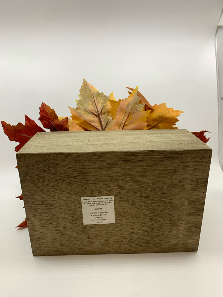 FAUX FALL FOLIAGE AND APPLES IN WOODEN BASKET.